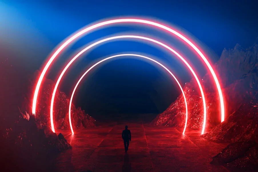 person walking through lit semi circles